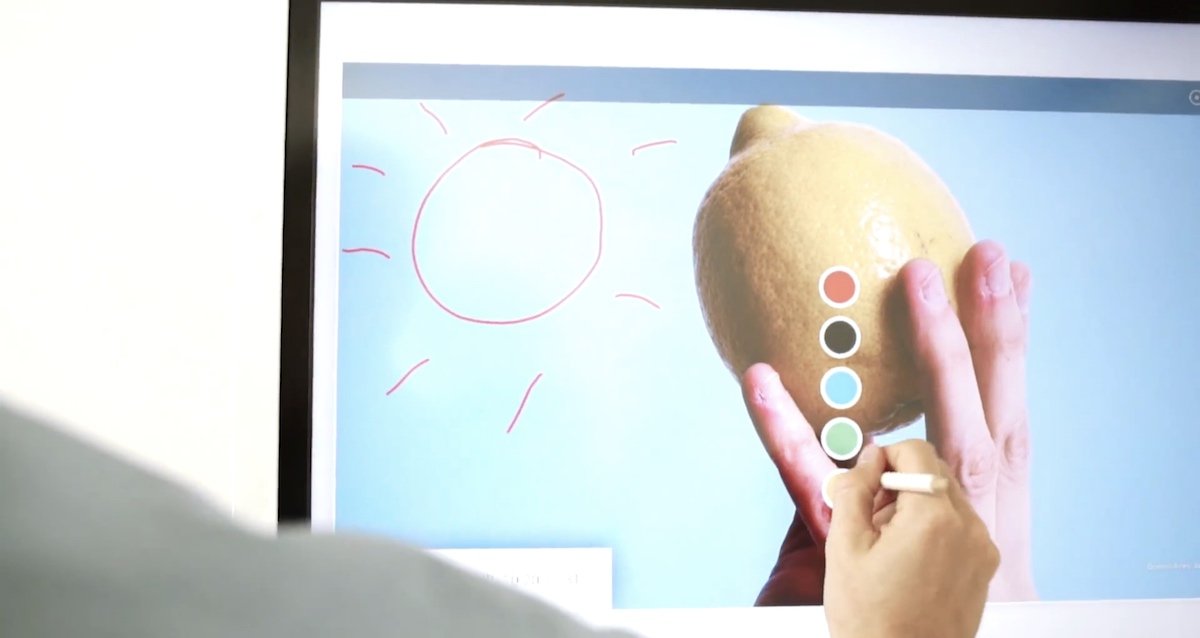 A Samsung Flip screen showing a person drawing on the interactive display